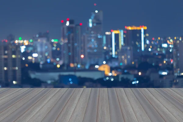 Opening wooden floor, Blurred bokeh city light background at night