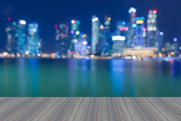 Opening wooden floor, Singapore city Skyline at Night- Blurred — Stock Photo, Image