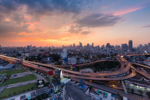 Beautiful sunset of Bangkok city downtown with main highway interchange