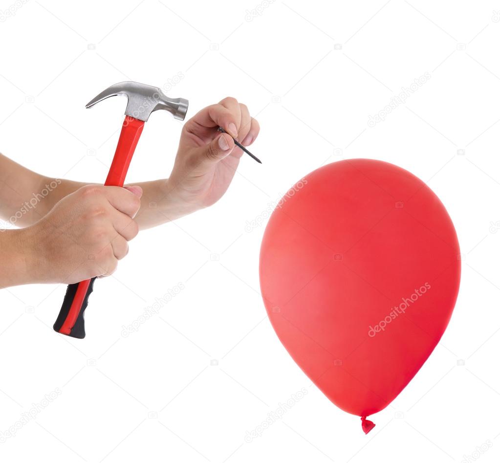 Man hitting a nail into a red balloon on the white background