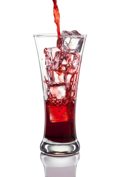 Red drink poured with a splash of ice cube — Stock Photo, Image