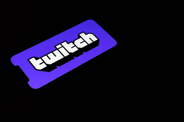 西班牙，格拉纳达2021年8月25日。Icon of the twitch mobile application on a black background on an iphone 12. twitch logo. — 图库照片