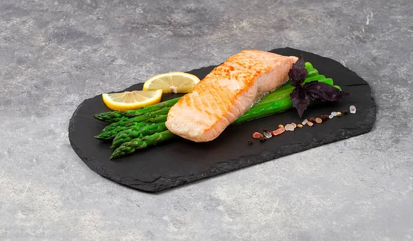 Dish, salmon fillet, with asparagus, on black slate, top view, horizontal, no people,