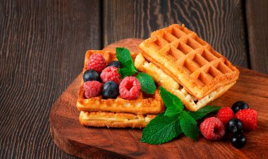 Viyana waffleları, böğürtlen ve nane ile, ahşap bir masada, yatay, insan yok.,