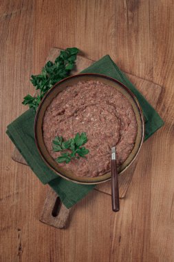 Red bean lobio,a traditional Georgian dish, on a wooden table, homemade,