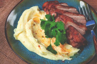 Kızarmış ördek göğsü, patates püresiyle dilimlenmiş, tabakta, yakın plan, insan yok.,