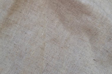 Sert keten kumaş gelişigüzel katlanmış. Tekstil arkaplanı
