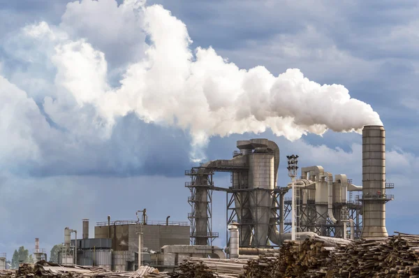 Silos, chimney, smoke and stormy sky. — Stock Photo, Image