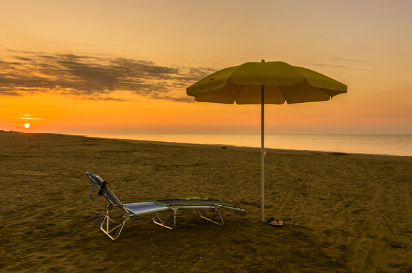 umbrella on the beach at sunrise