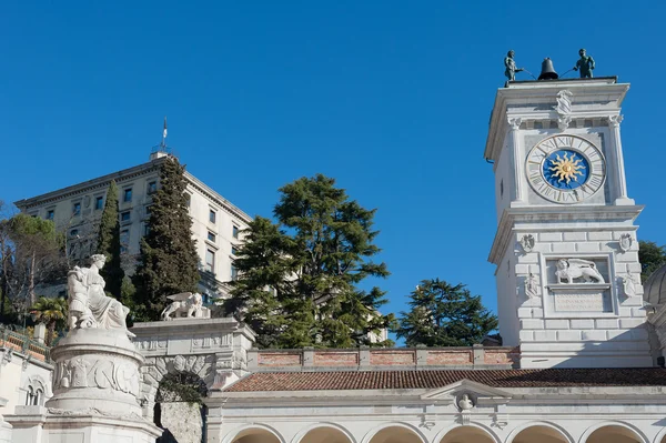 The statue of Peace with the clock tower of the church. — Stock Photo, Image