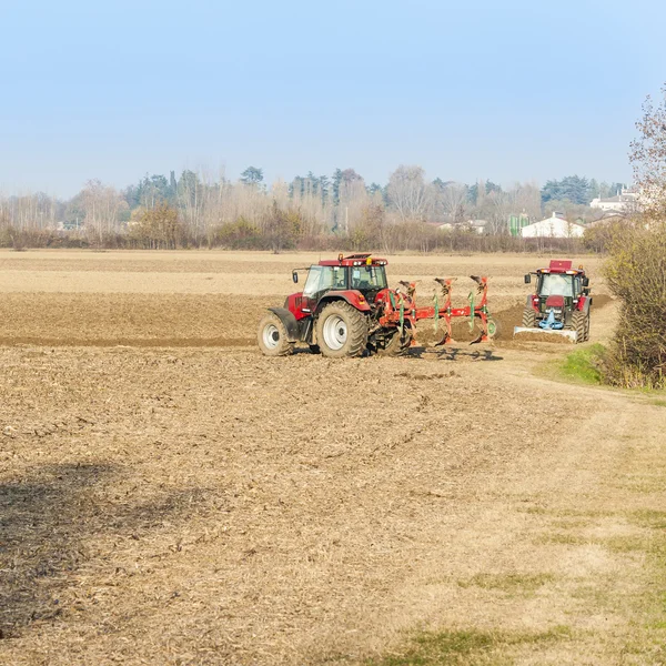 Piros traktor, őszi szántás. — Stock Fotó