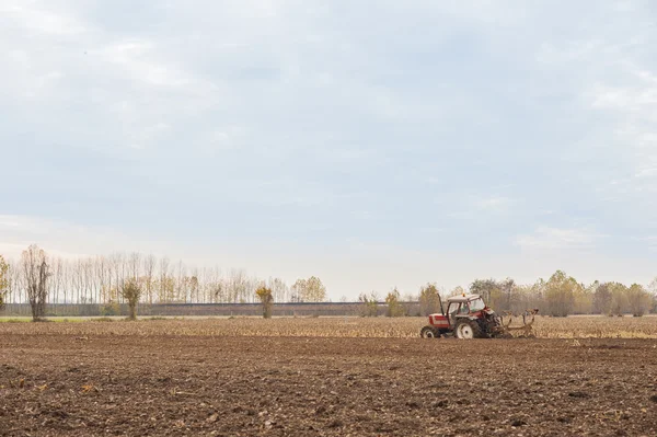 Red Tractor Plowing in Autumn — Stock Photo, Image