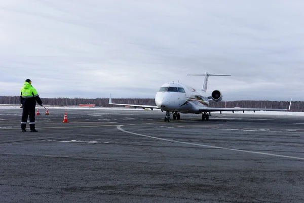 The passenger Bombardier CRJ 100 plane of RusLine airline comes around on the parking — Stock Photo, Image