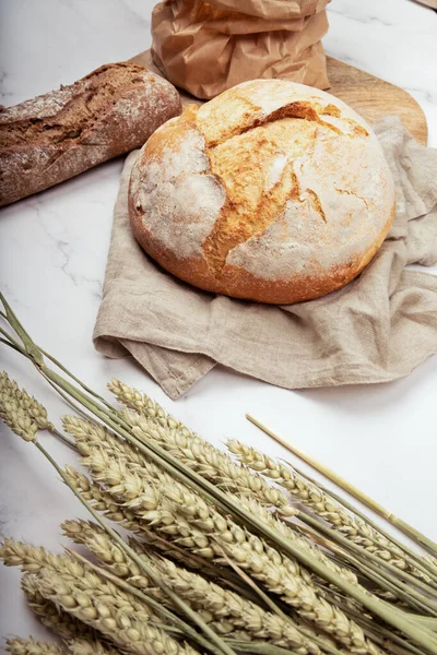 Artisan bread with wheat cereals on a stone table