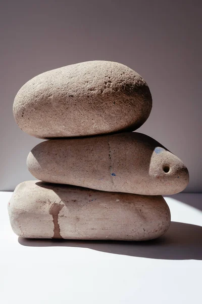 Balancing stones. Stones for spa treatments on a white background. The concept of meditation on the stones is stacked in a pyramid.