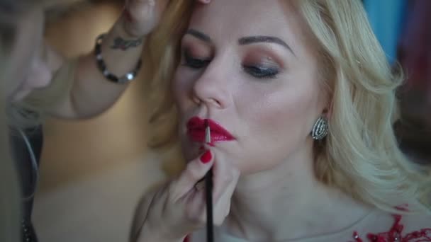 Vrouw rode lippenstift toe te passen. Prachtige model - maken omhoog-lips. Make-up artiest toepassing make up — Stockvideo