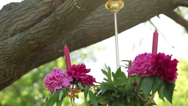 Hängande ljus dekorerade med fina blommor. Bröllop in i trädgård, park. utanför bröllopsceremonin. — Stockvideo