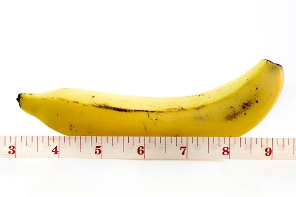 Grande banana e nastro di misurazione Fotografia Stock
