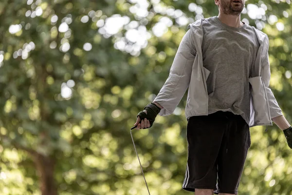 View of a sporty person jumping the wire in a public park, view of a person doing sport exercise, Lisbon, Portugal.