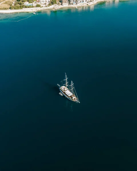 Aerial view of a small sailing boat navigating the blue water on Mediterranean Sea in Slano, Dubrovnik, Croatia.