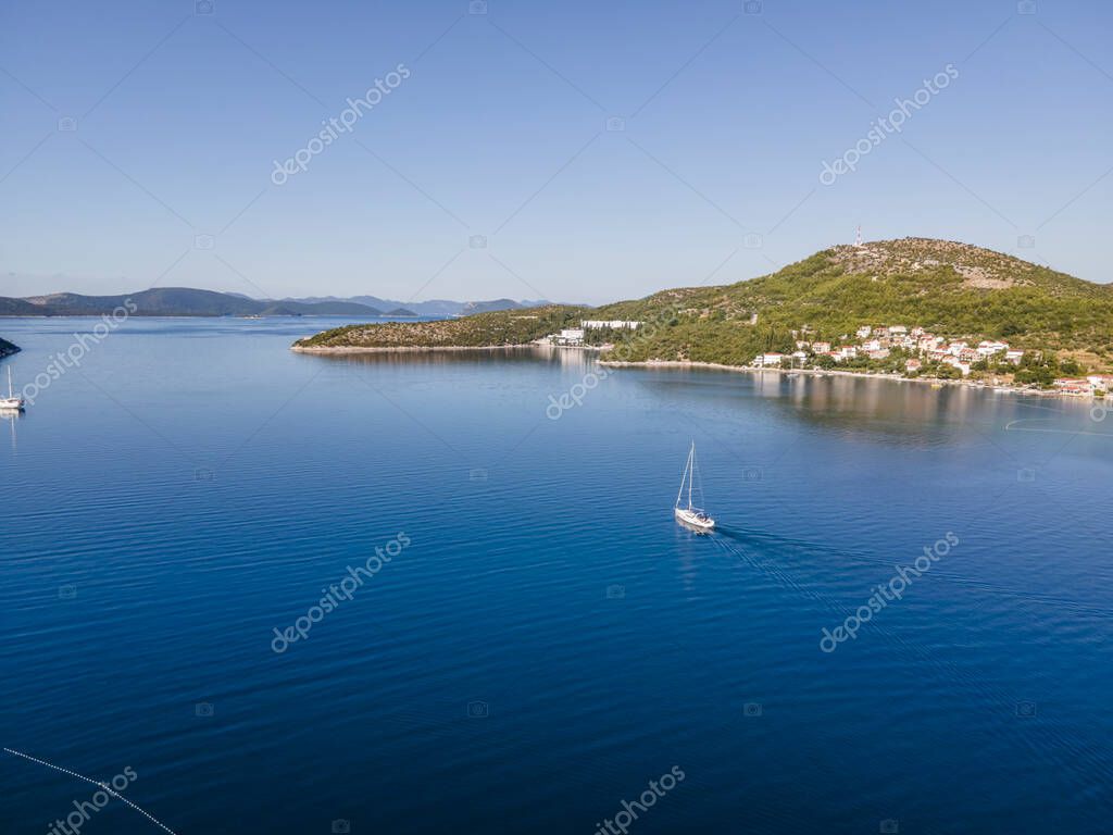 Vista aérea de un velero navegando por las tranquilas aguas a lo largo