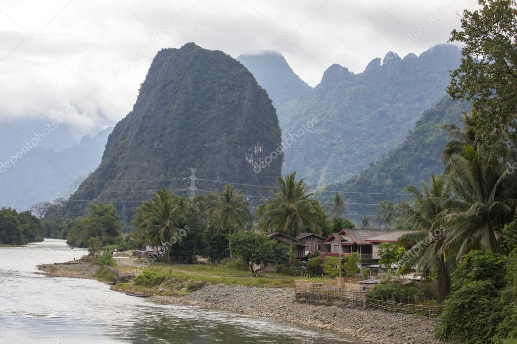 Houses and mountains are located along the coast Nam song river Vang Vieng,Laos.