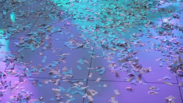 People shadows on dance floor at youth party with shiny confetti — Stock Video