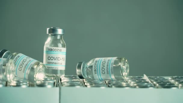 Medical vials or bottles with anti coronavirus vaccine or other pharmacy drugs on boxes — Wideo stockowe