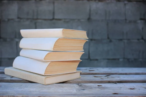 Books on a wooden box, books in an industrial setting