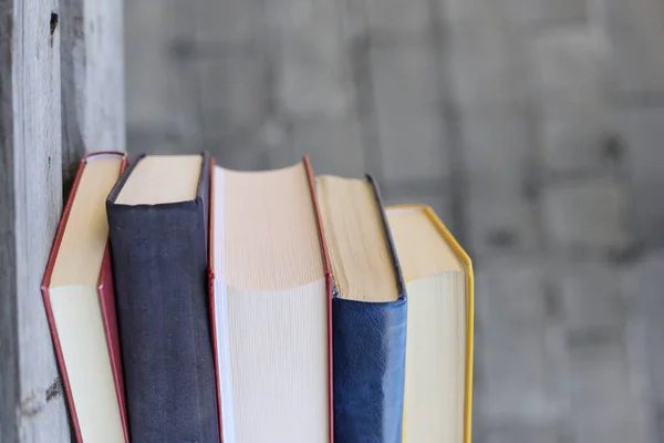 Books on a wooden box, books in an industrial setting