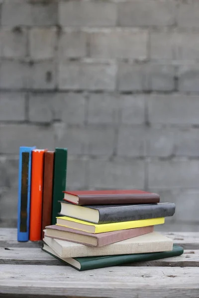 Books on a wooden box, books in an industrial setting