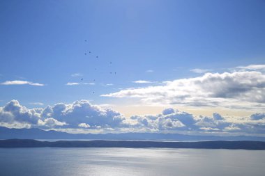 Hırvatistan 'da Adriyatik Denizi üzerindeki mavi gökyüzünde beyaz bulutlar