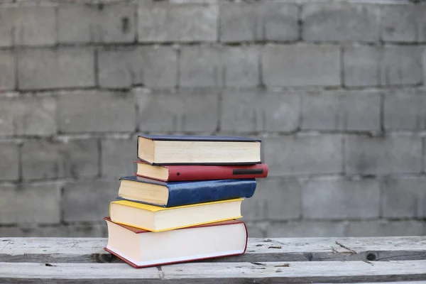 Books on a wooden box, books in an industrial setting