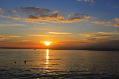 Sunset on the sea in front of Makarska, Croatia clipart