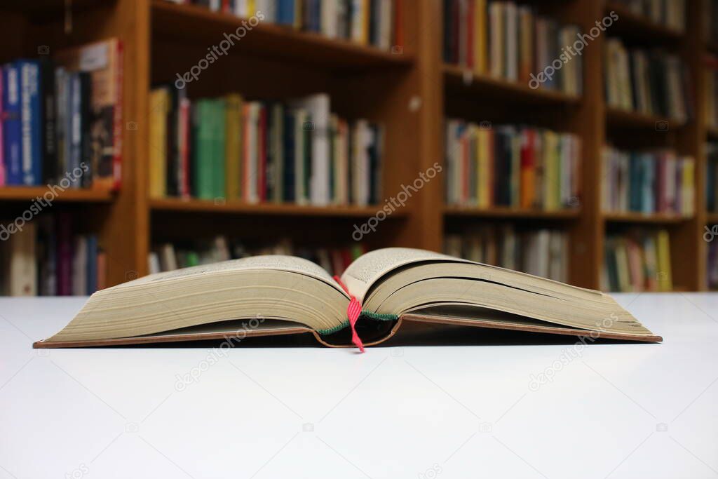 Open book on the table in library