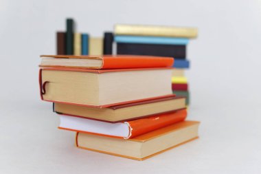Beyaz arkaplanda bir yığın turuncu kitap