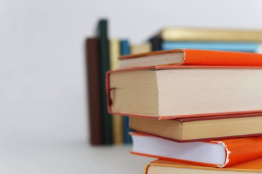 Beyaz arkaplanda bir yığın turuncu kitap