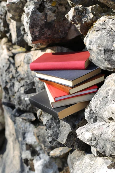 Books on the stone wall