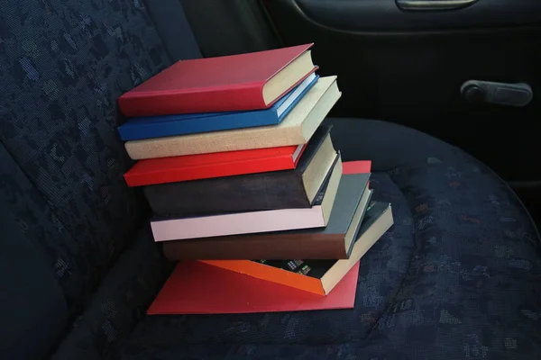 Books in the back seat of a car