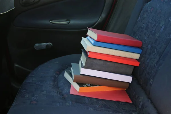 Books in the back seat of a car