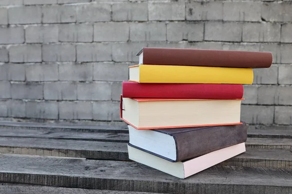 Books on a wooden box, books in an industrial setting