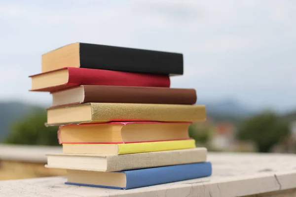 Stack of books on the wall in front of the school