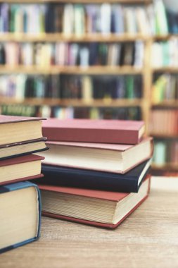 Tahta masadaki kitap yığını.