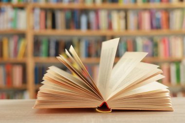 book on wooden table in library