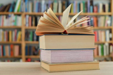 Kütüphanedeki masanın üzerinde kitap yığını