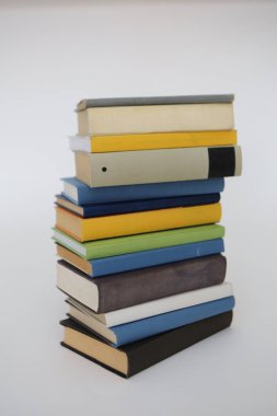 Beyaz arkaplan üzerine kitap yığını.