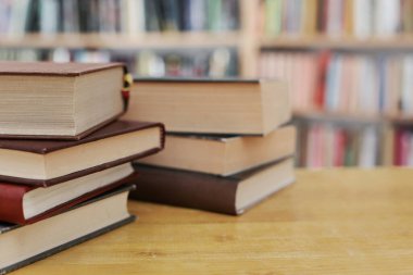 Tahta masadaki kitap yığını.