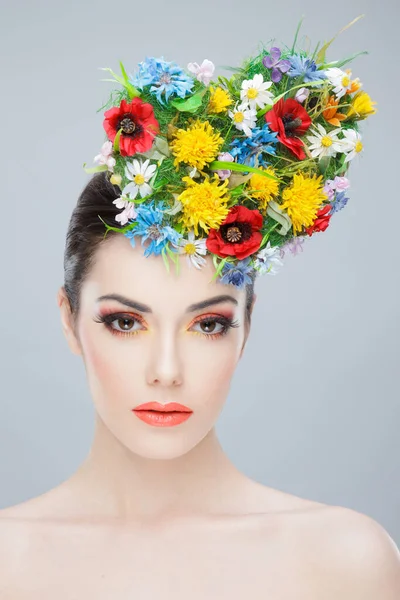 Skönhetsporträtt framifrån. Vacker flicka med våren färgglada blommor. Skönhetsansikte. Kreativ make up och frisyr. — Stockfoto