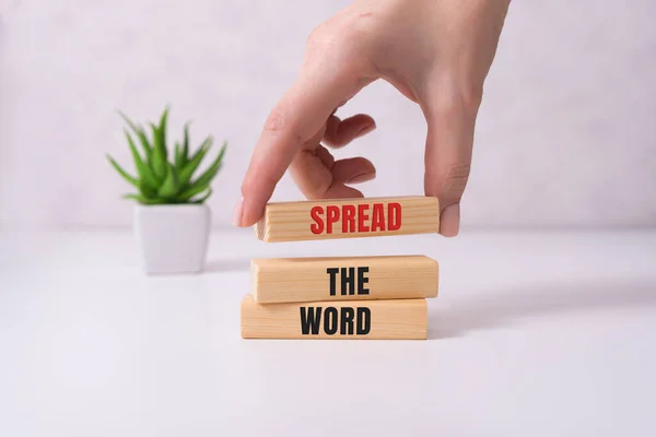 Spread thw word, a word written on a wooden block. Spread the word text on the table, concept — Stock Photo, Image