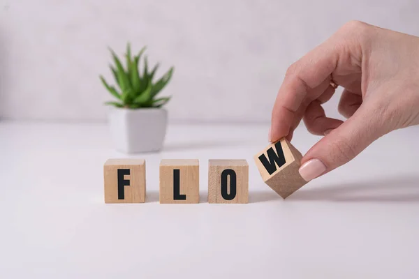 Word flow. Wooden small cubes with letters isolated on white background with copy space available.Business and finance concept. — Stock Photo, Image
